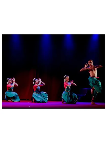 A dynamic moment where I lead the ensemble in "Tyāgarāja Hṛt Sādana." The contrast between my energetic pose and the seated dancers creates a visually interesting composition.