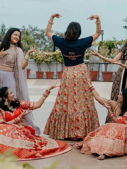 The choreographer with her past brides, a testament to the strong relationships built.