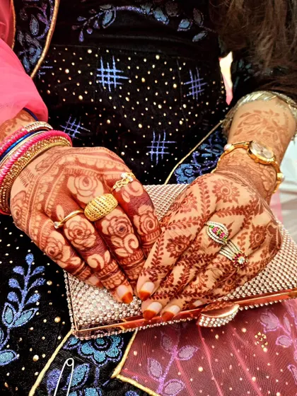 A lovely shot of the henna stain, paired with a sparkling clutch and beautiful rings.