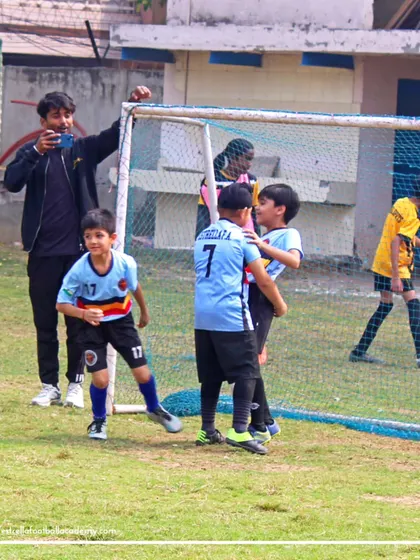 Celebrating a goal right in front of the net. I foster an environment where players celebrate their successes together as a team.
