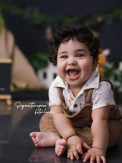 A beautiful, clear shot of the happy 9-month-old enjoying his safari adventure. The lighting is carefully controlled to create a bright and cheerful portrait.