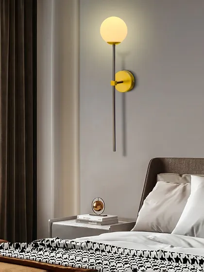 The globe sconce used as a bedside light, offering a simple and modern solution.
