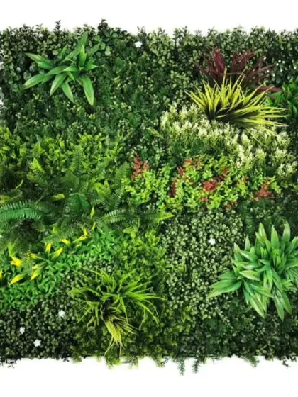 A sample panel of a mixed tropical green wall. It includes artificial ferns, broadleaf plants, and colorful accents, showing the variety available for custom designs.