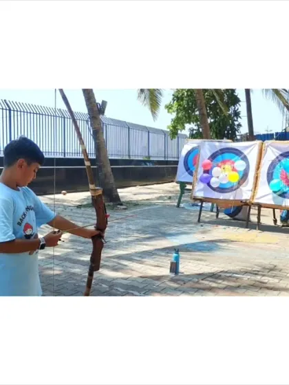 We mix serious practice with fun challenges. This student is taking aim at our balloon-popping targets, a camp favorite that helps improve accuracy under pressure.