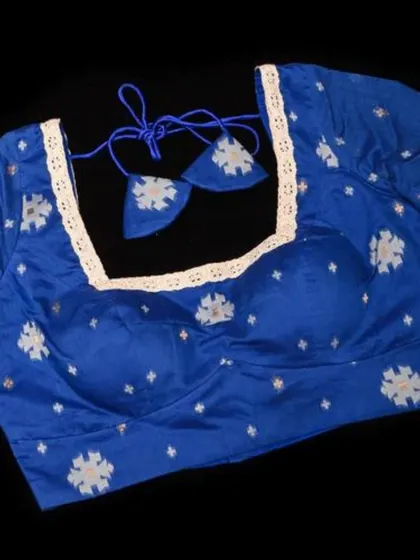 A blue Jamdani cotton blouse with a square neckline and traditional motifs.