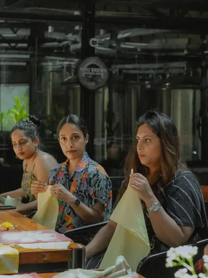 Participants at a workshop, fully engaged in preparing their fabrics for dyeing. I love the focused, creative energy that fills the room during these sessions.
