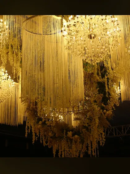 A ceiling installation of hanging tuberoses and crystal chandeliers, creating a fragrant and visually stunning canopy.