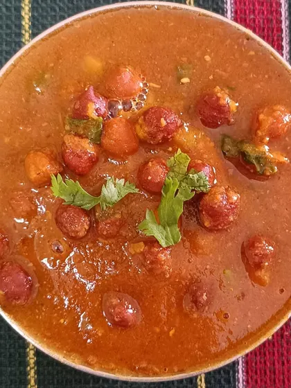 A close-up of the Black Channa Curry from my festive Christmas tiffin. The gravy is rich and thick, perfect for scooping up with a piece of roti or mixing with rice.