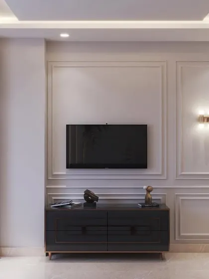 A simple yet elegant TV wall with classic moulding and wall-mounted sconces, demonstrating a timeless approach to living room or bedroom design.