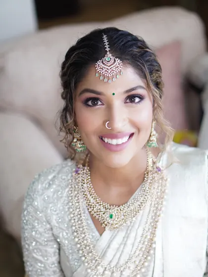 Meet Reshma, a stunning bride and talented wedding planner, radiating pure joy. Her engagement look was all about soft glam, with subtle hues to highlight her natural glow and sparkling smile.