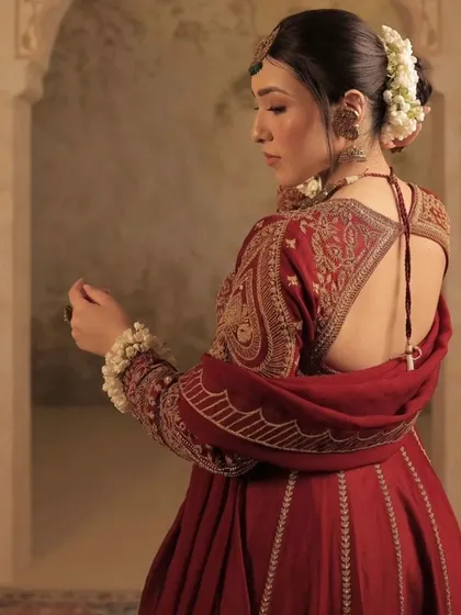 The side profile of the gajra bun, showing how the flowers beautifully frame the updo.
