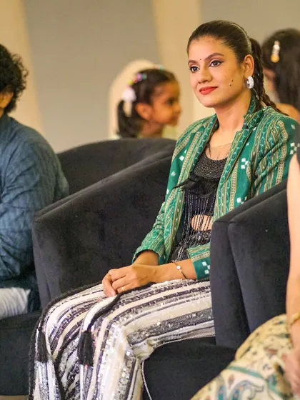 A candid moment watching other performances at an Odia cultural event. I am deeply connected to my roots and love celebrating our rich artistic traditions.