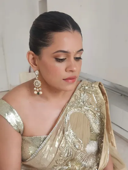 A close-up of Kirti's subtle glam eye makeup and glossy lips.