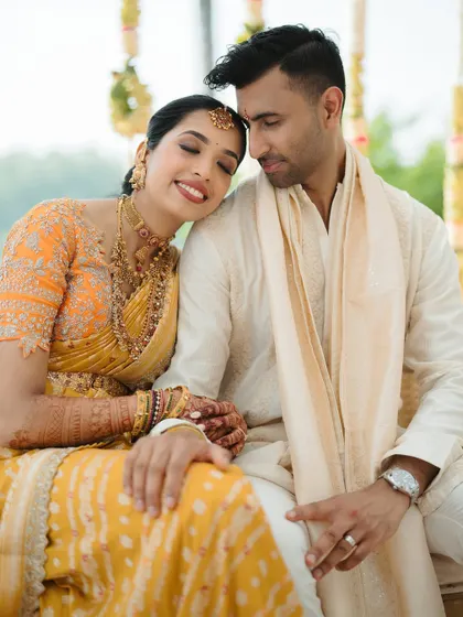 A tender moment of the bride resting her head on the groom's shoulder. It’s a quiet, intimate portrait that speaks volumes.