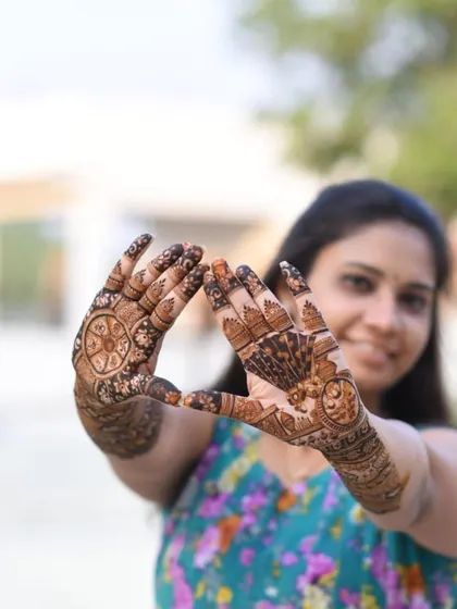 A creative pose highlighting the rich color of the henna.