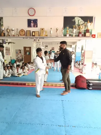 A student receives his new belt.