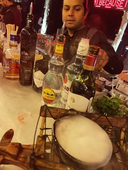 A glimpse of my mobile bar setup, complete with premium spirits and a smoking cocktail ready to be served. I ensure every detail, from the liquor selection to the presentation, is top-notch.