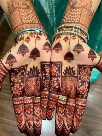 This design with hanging jhumkas (earrings) is very popular for festivals and parties. The dark, rich stain shows the quality of my organic henna.