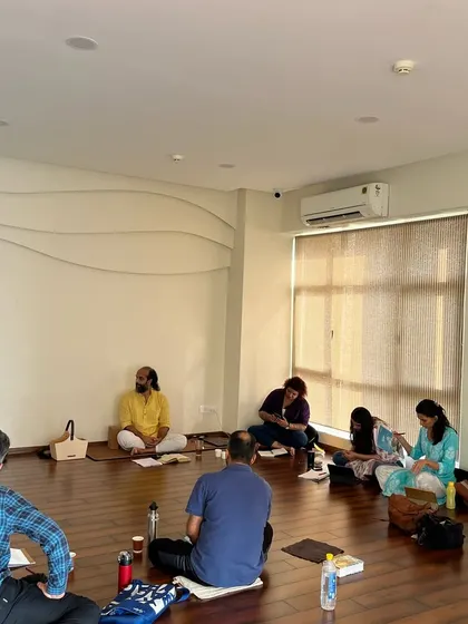 Students sit in a circle, taking notes and engaging in discussion during the Gītā Sār Vichār workshop. The atmosphere is one of shared learning and introspection.