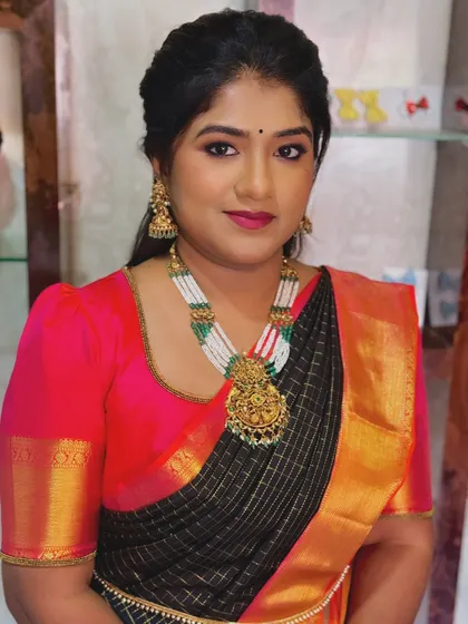A full-face look for Priya, showcasing a soft glam style. The bright pink lip adds a pop of color that complements her beautiful saree.