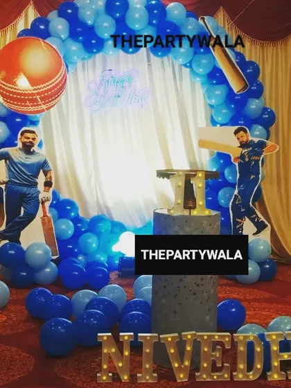 For the little sports fan, a cricket-themed birthday is a big hit. This setup features cutouts of famous players, a cricket ball balloon, and a blue balloon arch, perfect for a future champion.