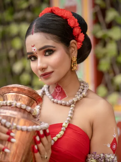 A close-up of a model in a cultural look, with traditional body art (alta) and a serene expression.