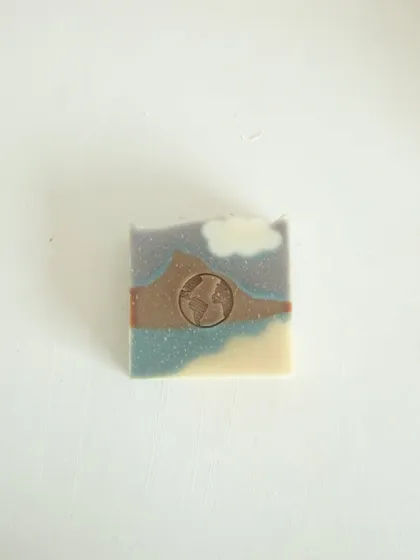 My Mountain Mist soap, scented with orange and cedarwood essential oils. It's colored with botanicals like indigo and hibiscus to capture the calm of misty mountains.