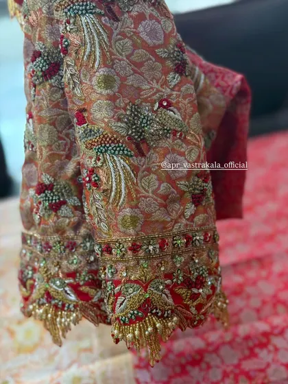 A brocade blouse with stunning peacock embroidery on the sleeves.