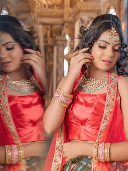 A creative shot showing the reflection of the bride, highlighting the beauty of the light blue Kundan set.