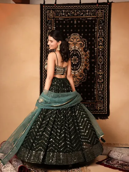 A back view of a sequined lehenga, essential for e-commerce to show customers all angles of the outfit. The movement in the dupatta adds a graceful touch.