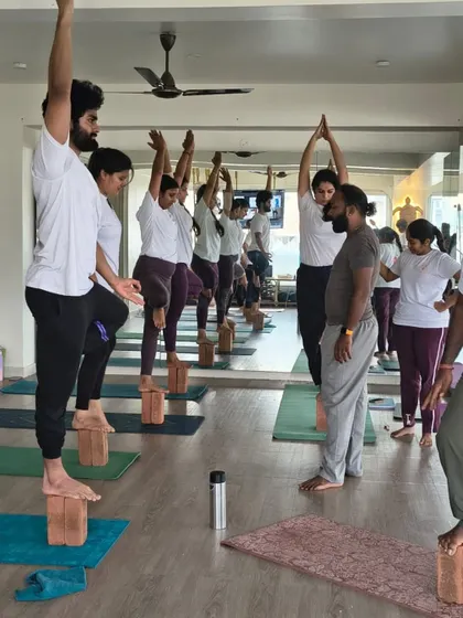Our guru observes and guides TTC students as they practice balancing poses on blocks. This hands-on approach ensures that every student receives the feedback they need to improve.