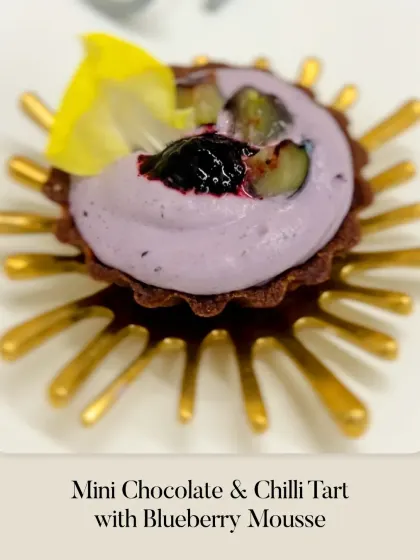 A Mini Chocolate & Chilli Tart with Blueberry Mousse. This bite-sized dessert plays with the classic combination of spicy and sweet.