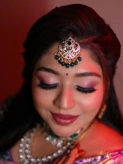 A beautiful close-up of the bride's makeup, highlighting her flawless eyeshadow and lipstick.