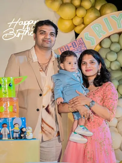 A family portrait from the Star Wars party, featuring a fun Baby Yoda (Grogu) and R2-D2 cake.