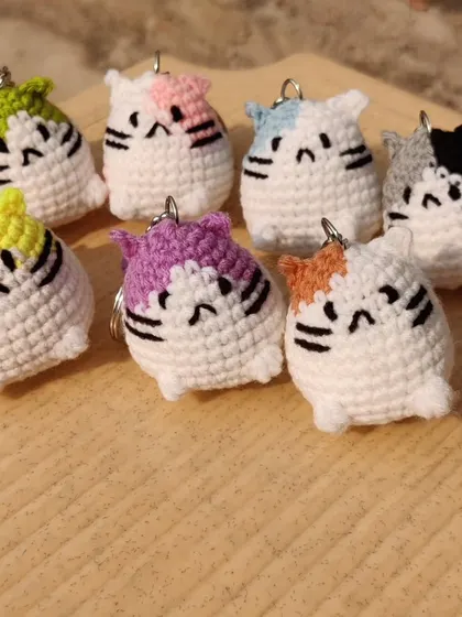 A whole family of colorful mini cat keychains.