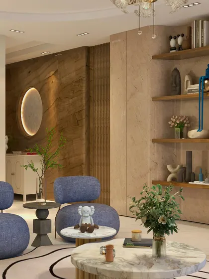 A detail shot showing the layering of textures, from the wooden wall paneling to the stone-textured console and plush blue chairs.