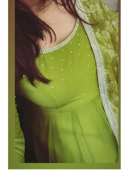 A close-up of the lime green Anarkali, showing the delicate sequin work on the bodice and the beautiful floral print of the organza dupatta.