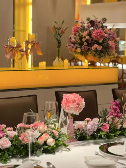 We transformed a restaurant space with beautiful pink floral arrangements, including a stunning cherry blossom tree centerpiece and lush table runners, creating a soft and romantic dining experience.