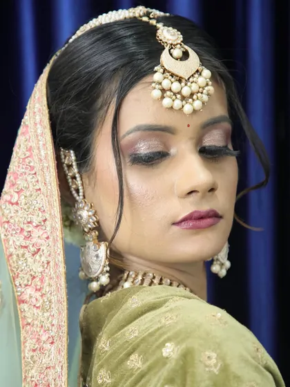 A glamorous bridal look with glittery eyes. This style is perfect for a bride who wants to make a statement at her reception or sangeet.