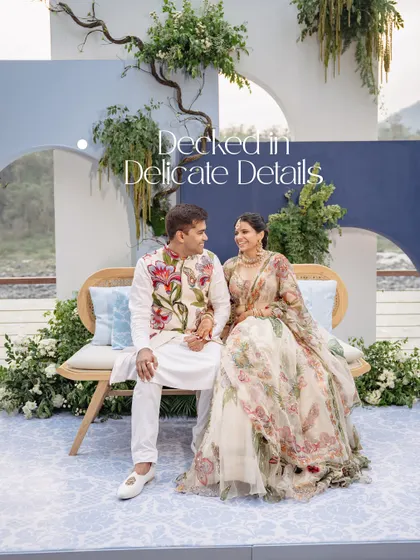 A portrait of the couple, 'Decked in Delicate Details.' The soft blue and white decor, combined with their floral outfits, created a picture of serene elegance.
