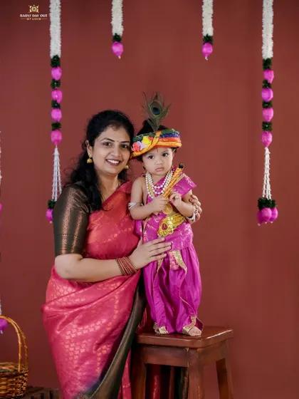 Another beautiful mother and child portrait for a Janmashtami photoshoot. The colorful outfits and traditional decor create a vibrant and culturally rich memory.