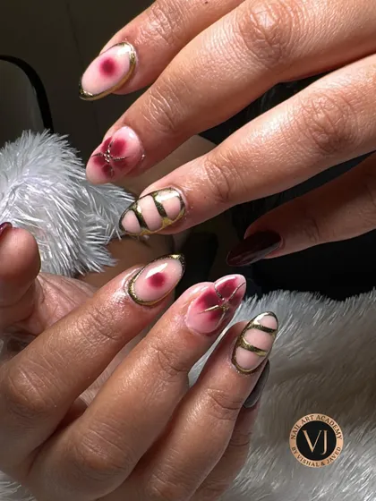 An elegant mix of deep wine florals and edgy gold geometric lines. This design showcases how to balance different artistic styles on one set of nails.