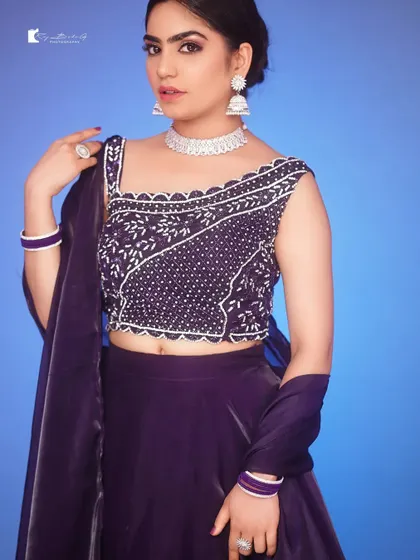 A model showing the details of the purple Indo-Western lehenga blouse.