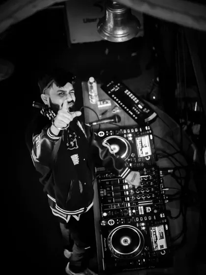 A duplicate of the previous image, offering another perspective on the DJ's craft from an overhead angle.