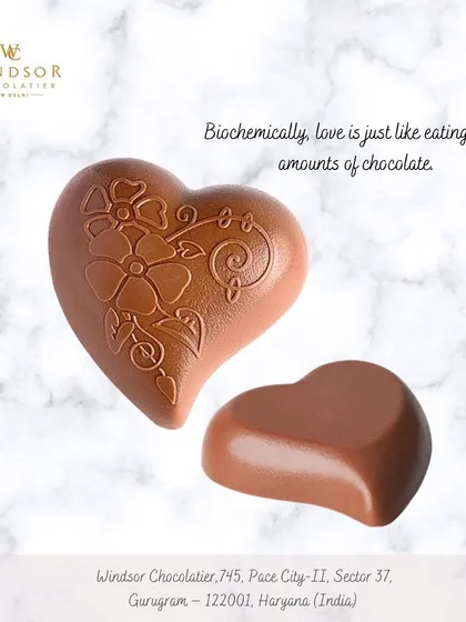 A set of two milk chocolate hearts, one with an intricate floral pattern and one smooth, showcasing different styles for a romantic gift.