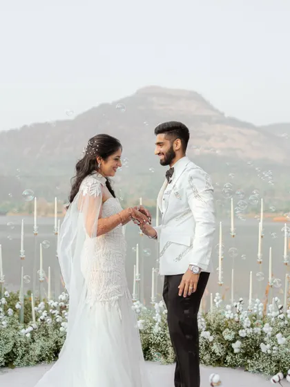 The couple exchanges rings with bubbles floating around them. This magical and whimsical shot adds a touch of fairytale romance to their ceremony.
