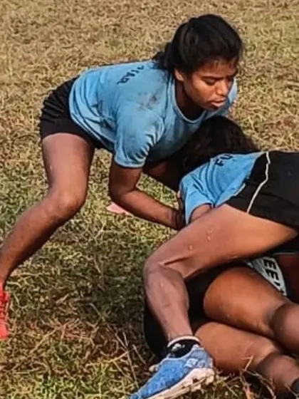 A powerful tackle during a girls' rugby practice. We are committed to creating opportunities for girls to participate in contact sports, building their strength, confidence, and resilience.