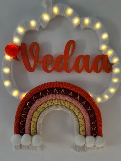 The 'Vedaa' name hanging lit up, creating a magical and warm ambiance perfect for a child's bedroom.