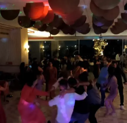 The party is still going strong, with guests dancing and having a great time.