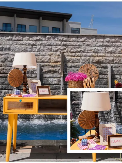 A detail shot of a yellow console table used in a Mehendi setup. The table is adorned with a lamp and other decorative items, showing my attention to creating small, styled vignettes within the larger space.